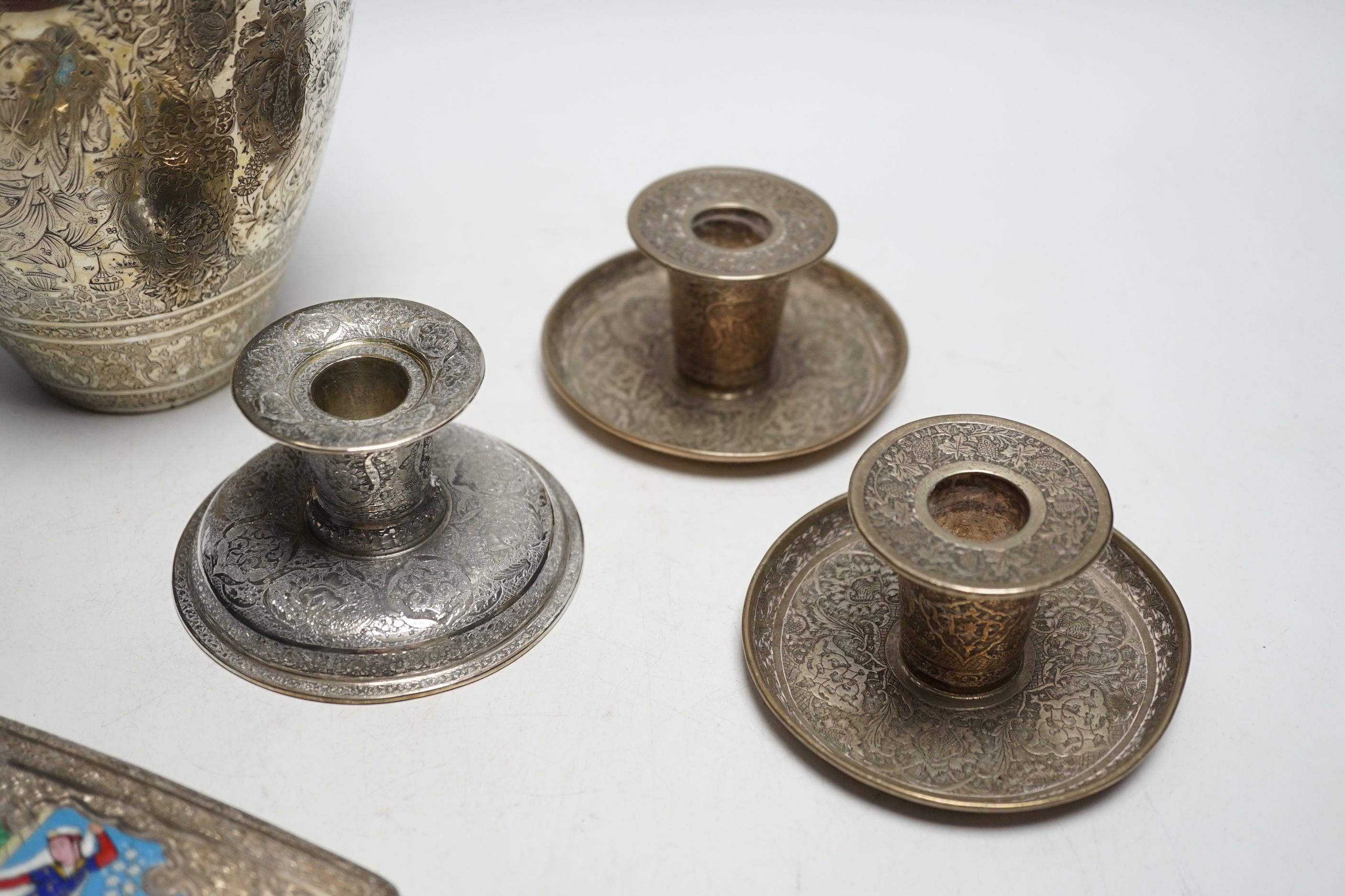 Three Persian white metal dwarf candlesticks including a pair, base 88mm, a similar white metal and enamelled cigarette case and a Persian metal vase.